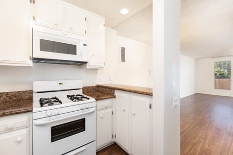 a kitchen with white appliances and white cabinets